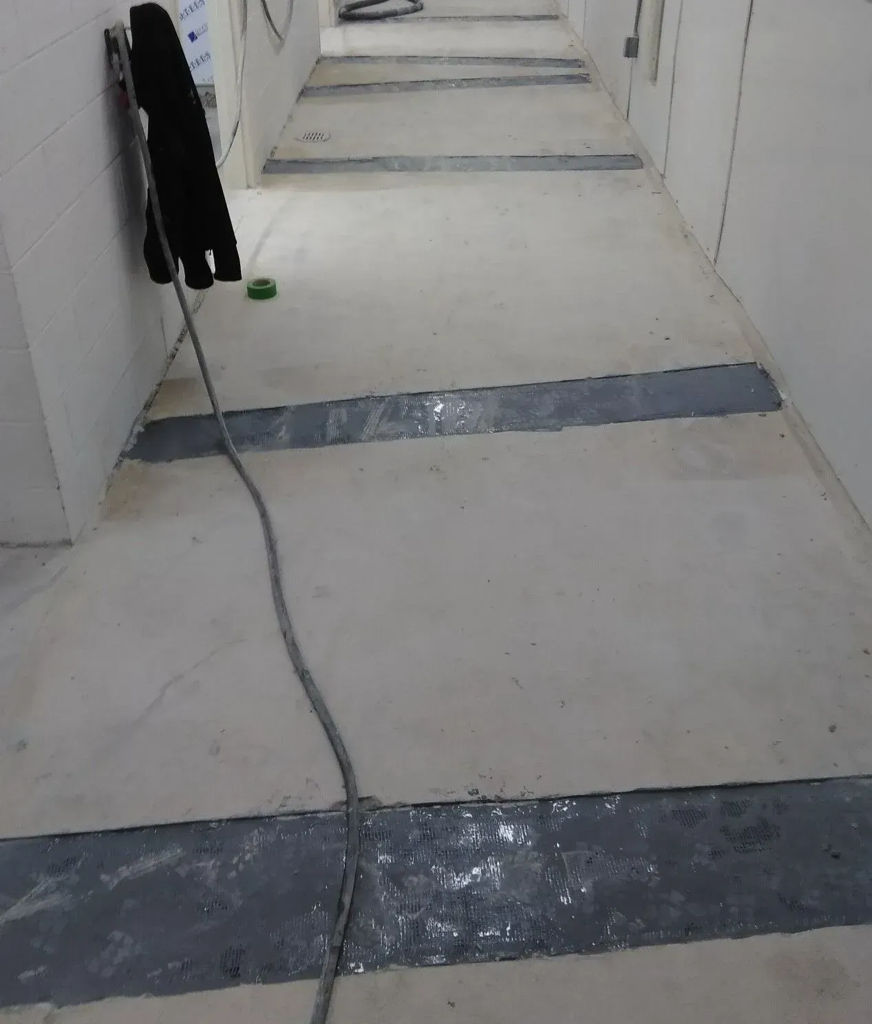 A long hallway with a telephone hanging on the wall
