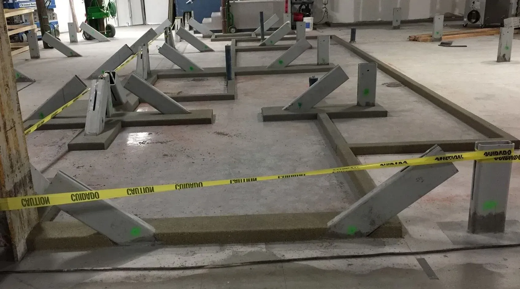 A construction site with a yellow tape that says caution