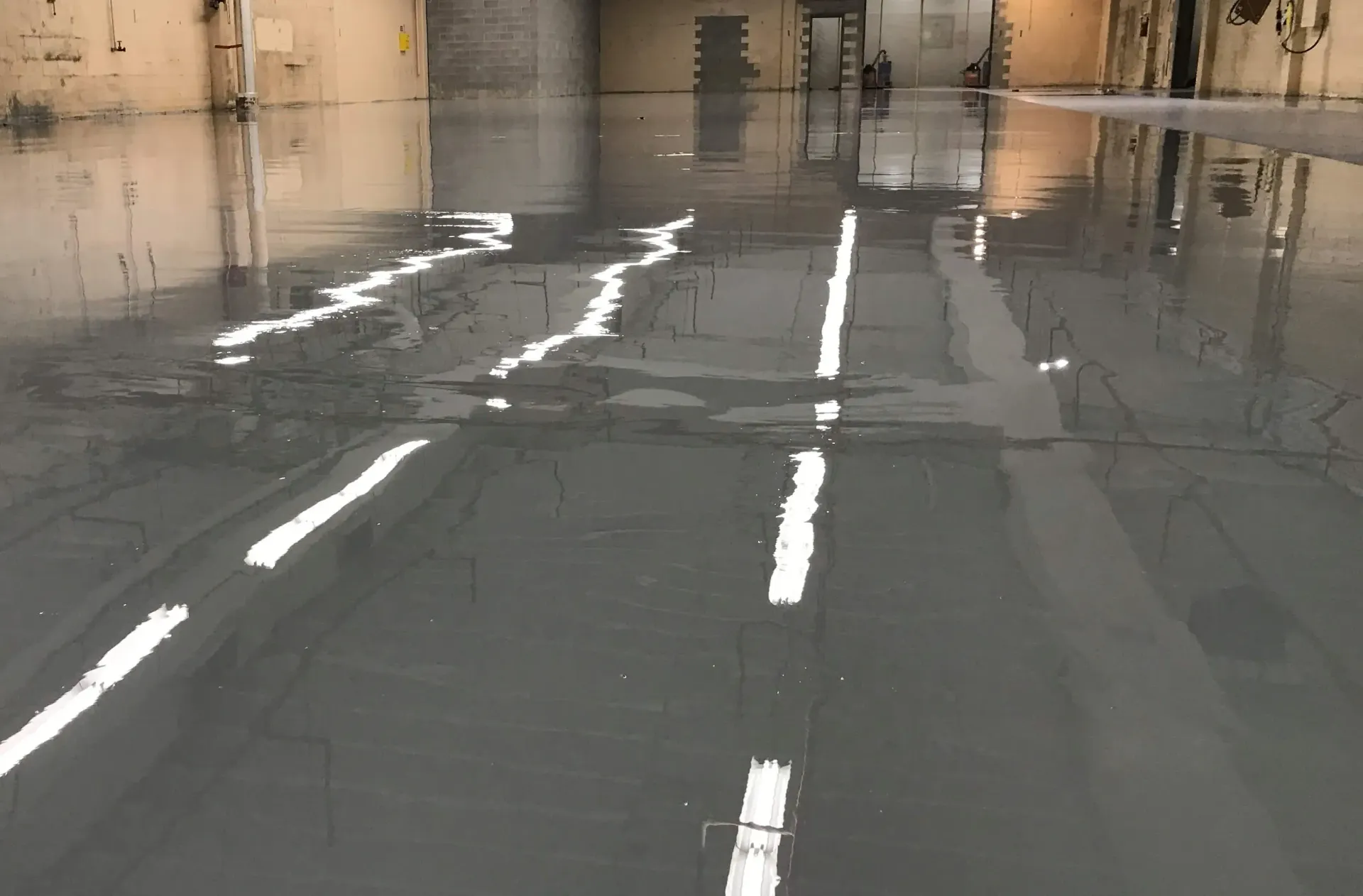 A concrete floor in a building that looks like a road.