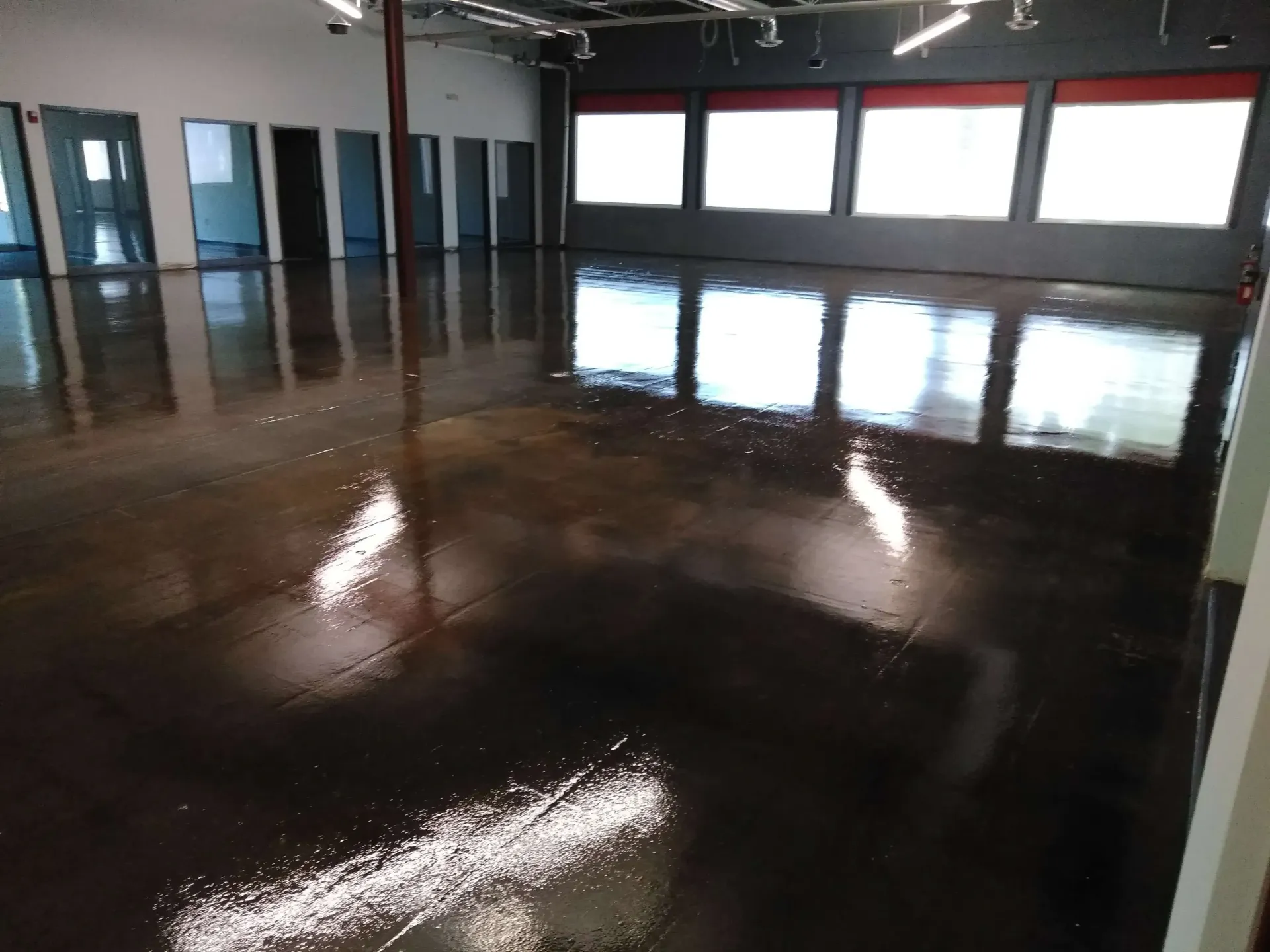 A large room with a shiny floor and lots of windows