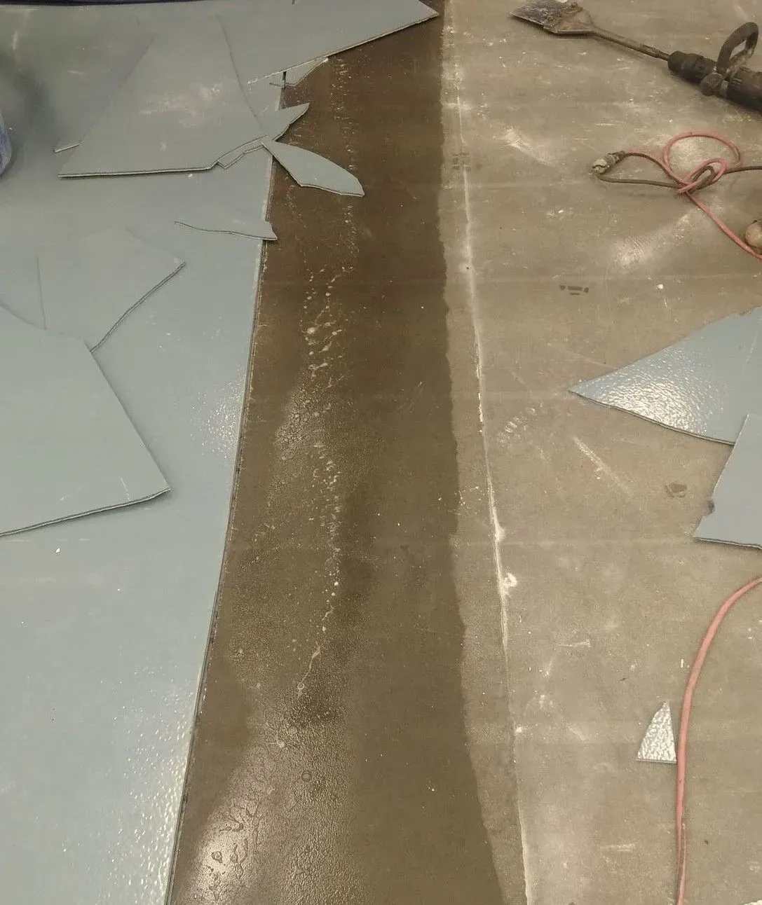 A concrete floor with a few pieces of concrete on it
