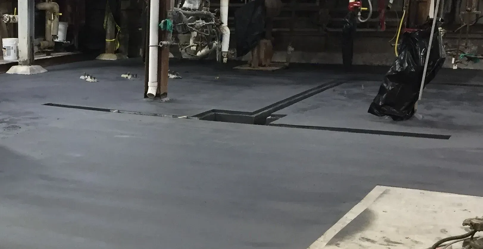 A person is standing on a concrete floor in a garage.