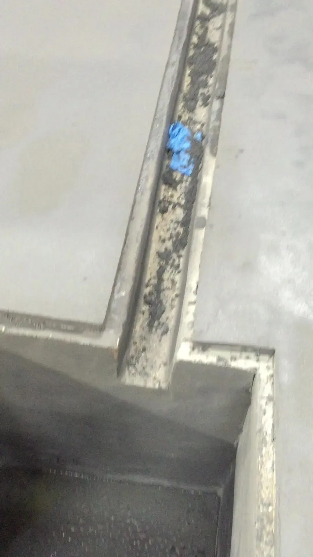 A close up of a metal object on a concrete floor.