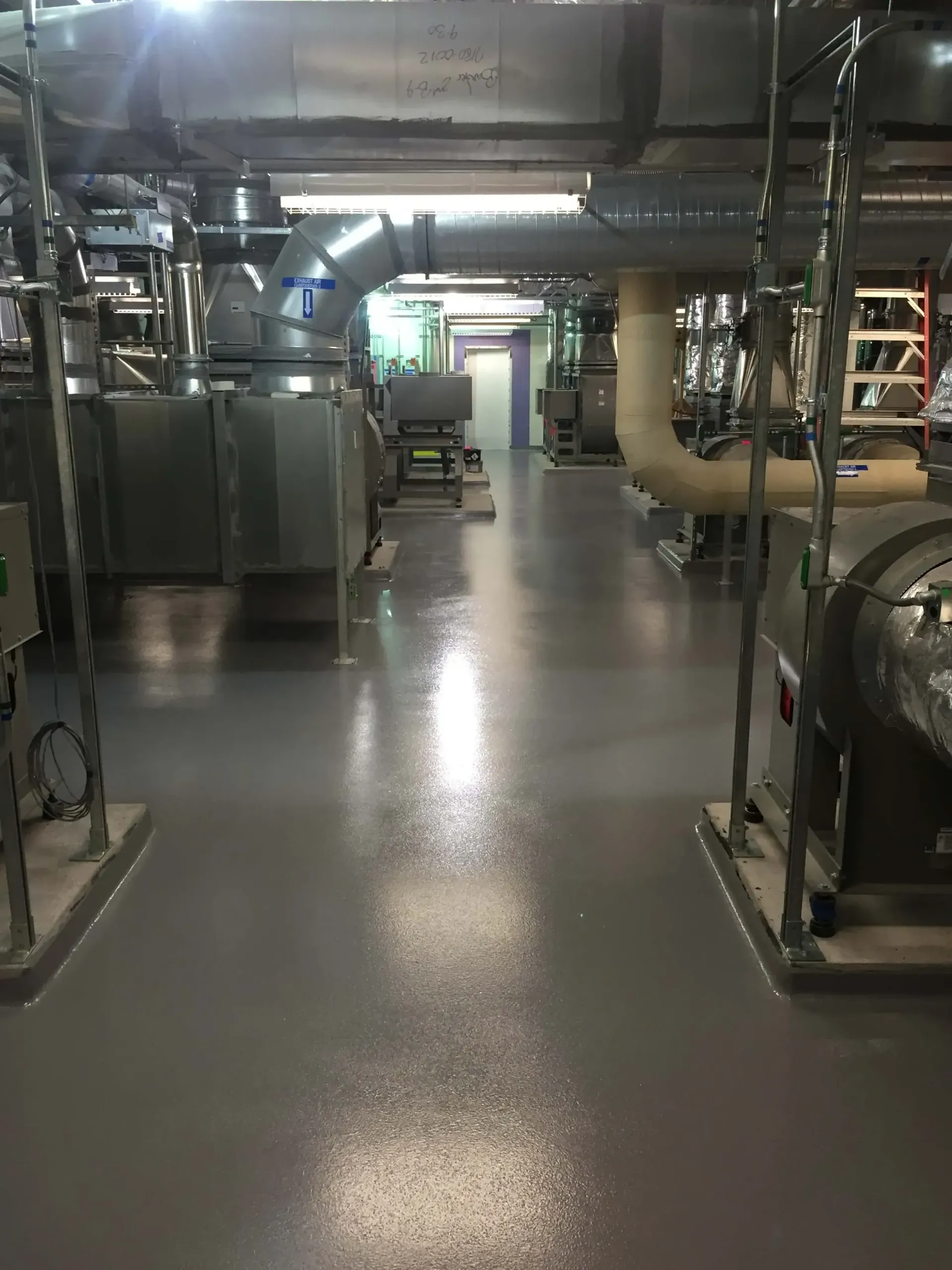A large room with a lot of pipes and machinery in it.