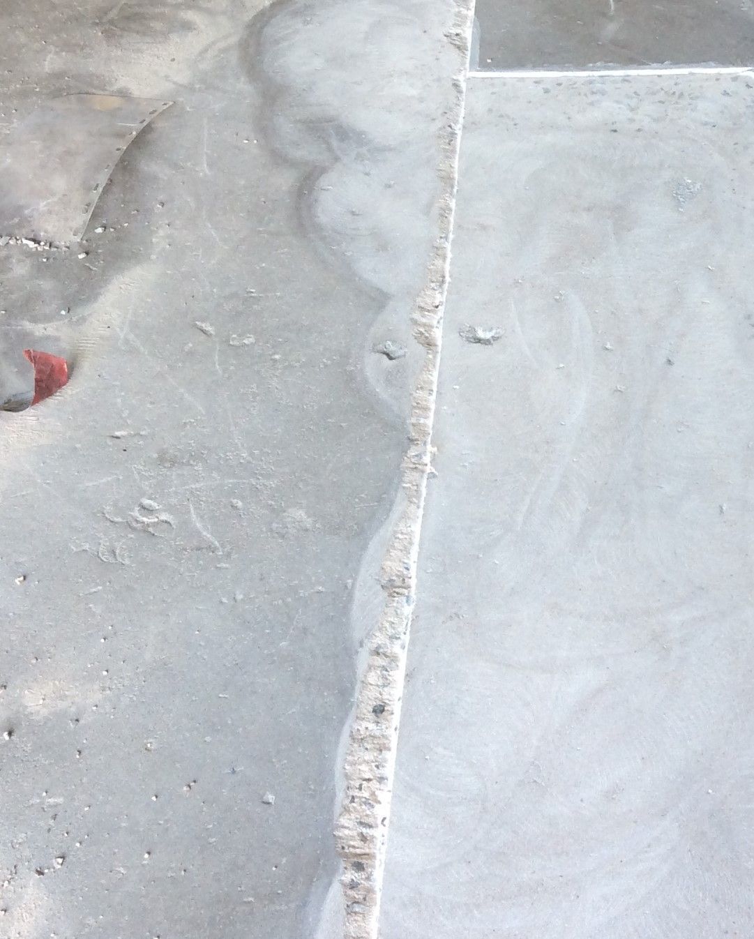 A close up of a concrete floor with a white border.