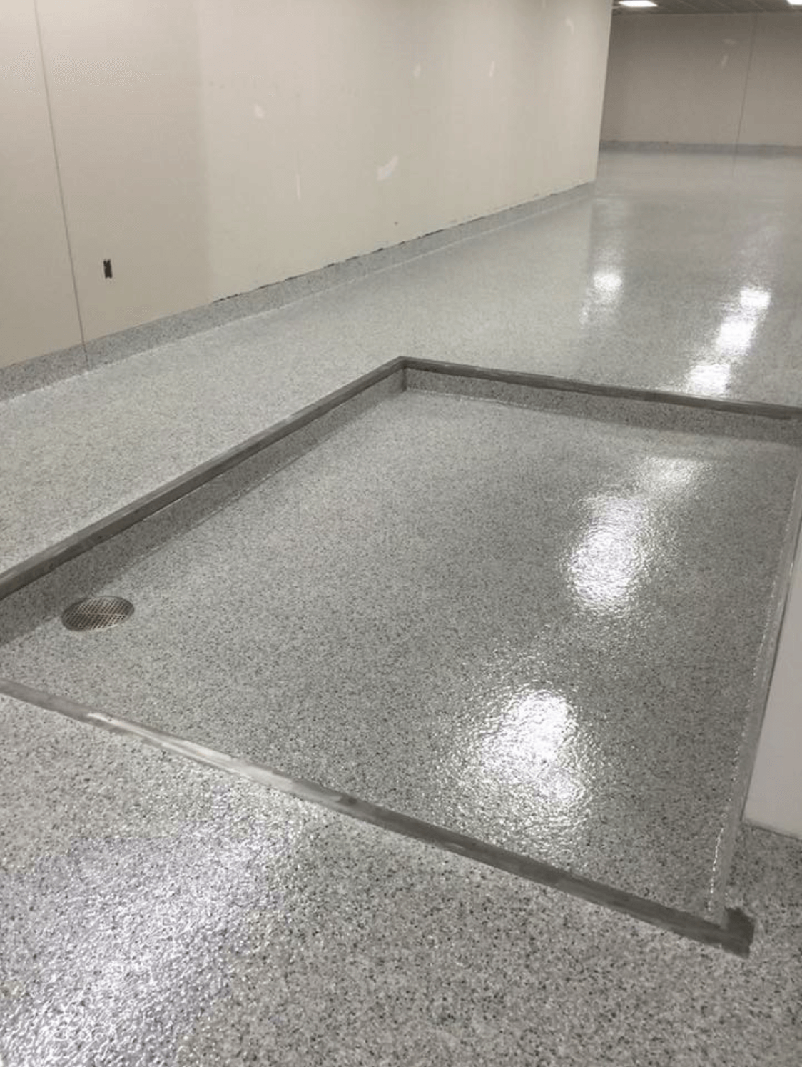 A concrete floor with a hole in the middle of it.
