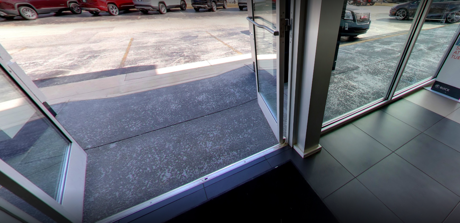 A sliding glass door is open surface with decorative concrete