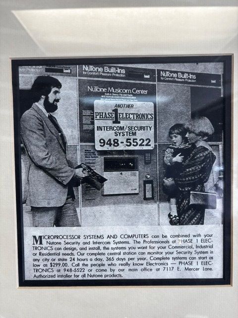 Black-and-white framed collage of a man and woman, with a central sign reading “Politics” and a phone number.