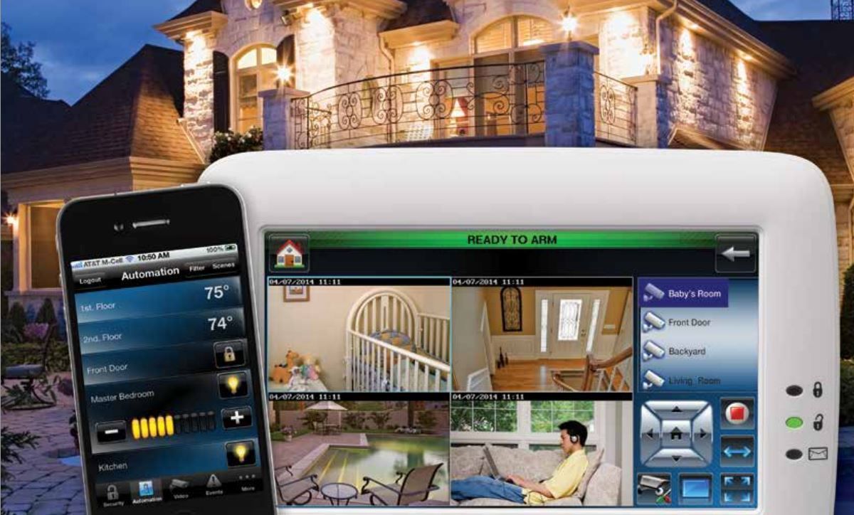 Smartphone and tablet showing a home security app in front of a lit house at night