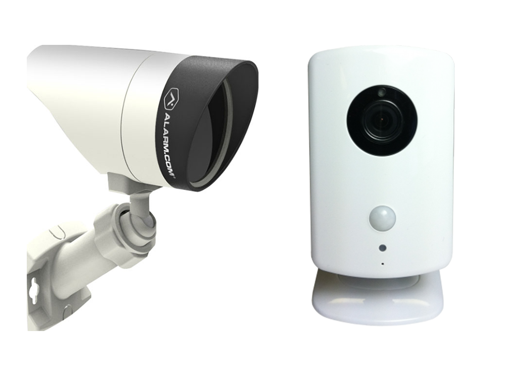 Two white security cameras, one mounted on a bracket and one standing upright