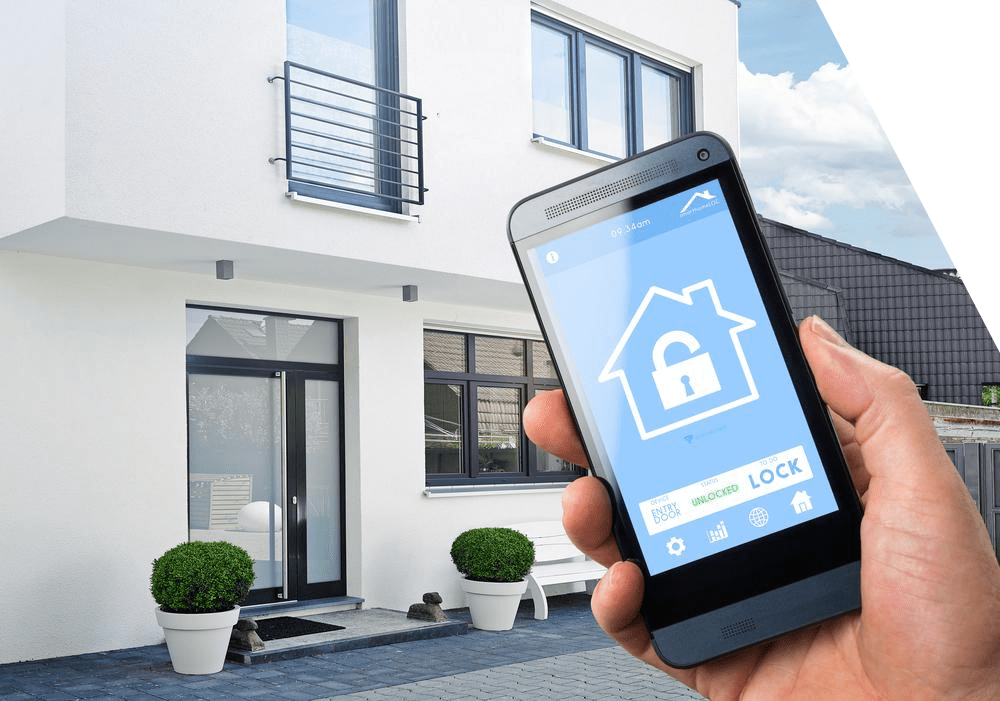 Hand holding a smartphone showing a home security lock icon in front of a modern house