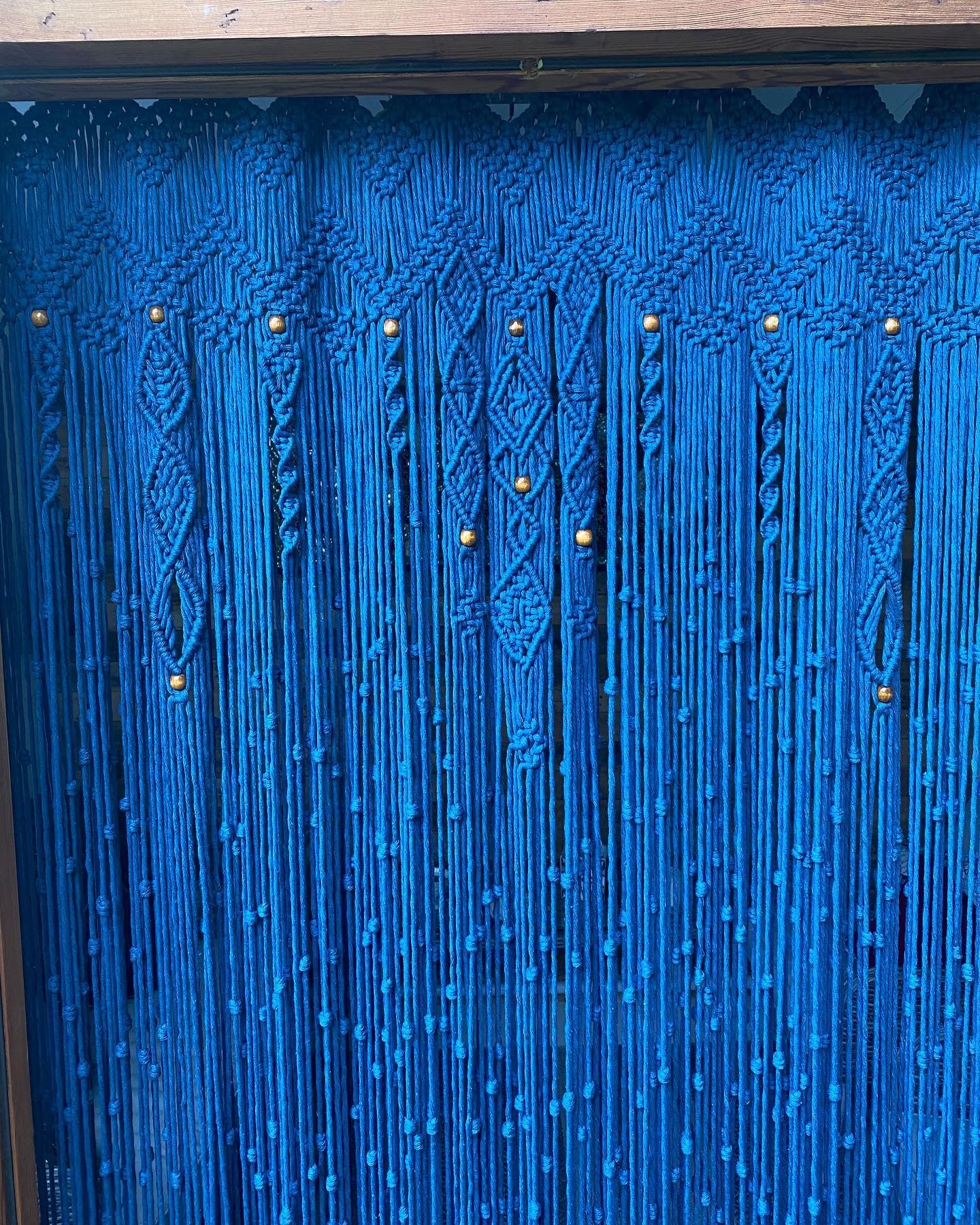 Macrame curtain close up showing knots and beads