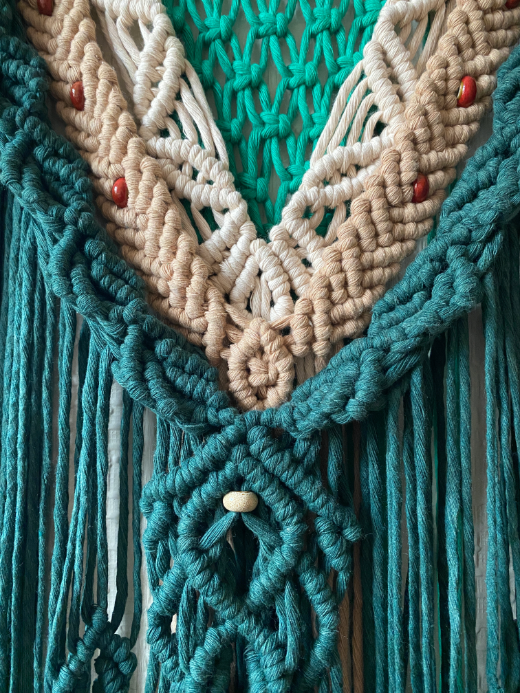 Close up: A wall hanging in 4mm cotton cord. The style is intended to emulate nature with leaves and berries. Made for Karen.