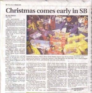 Newspaper article with headline “Christmas comes early in SB” and a photo of people around stacked holiday gift boxes