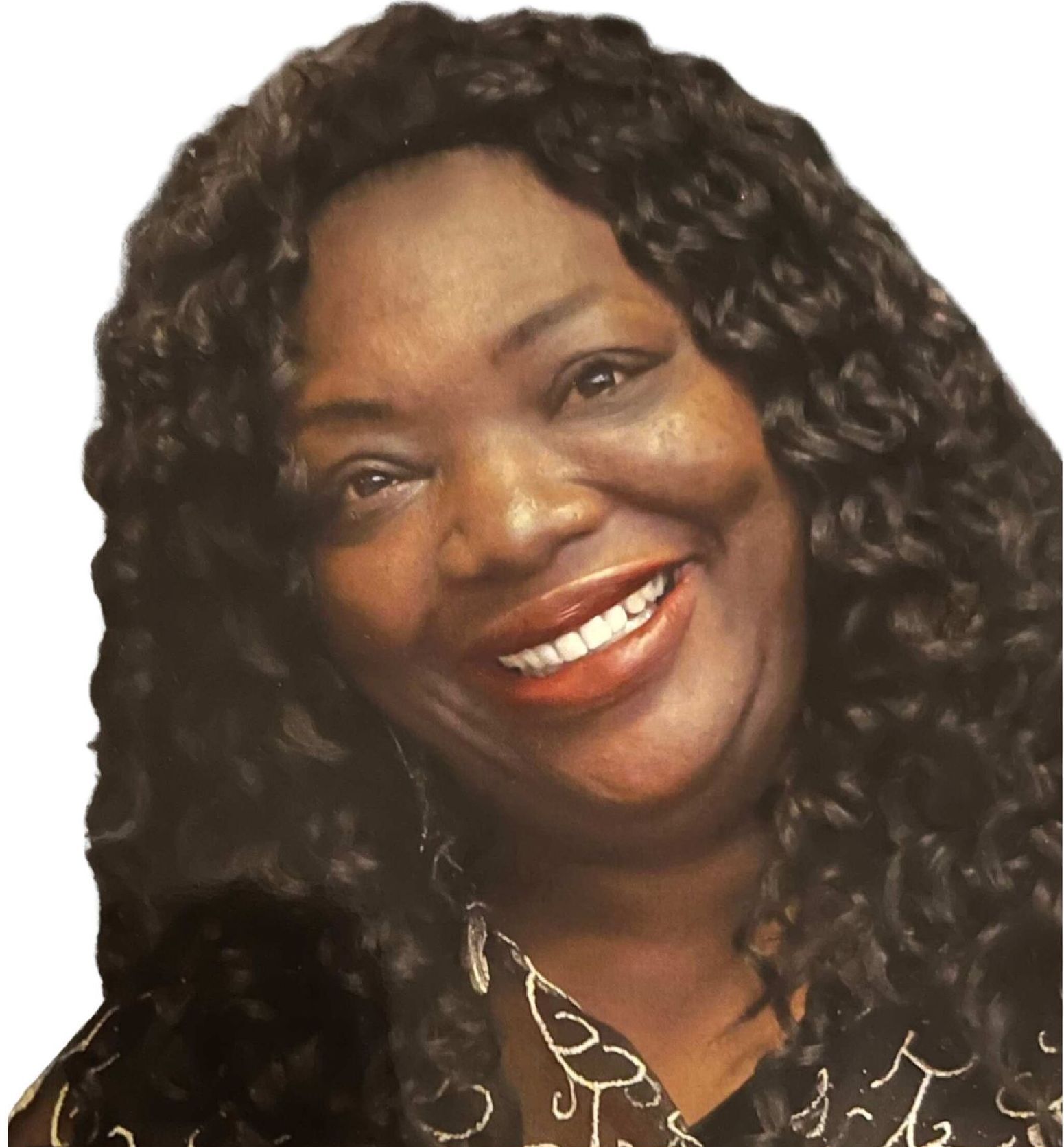 Smiling woman with long curly dark hair in a patterned black blouse on a light background