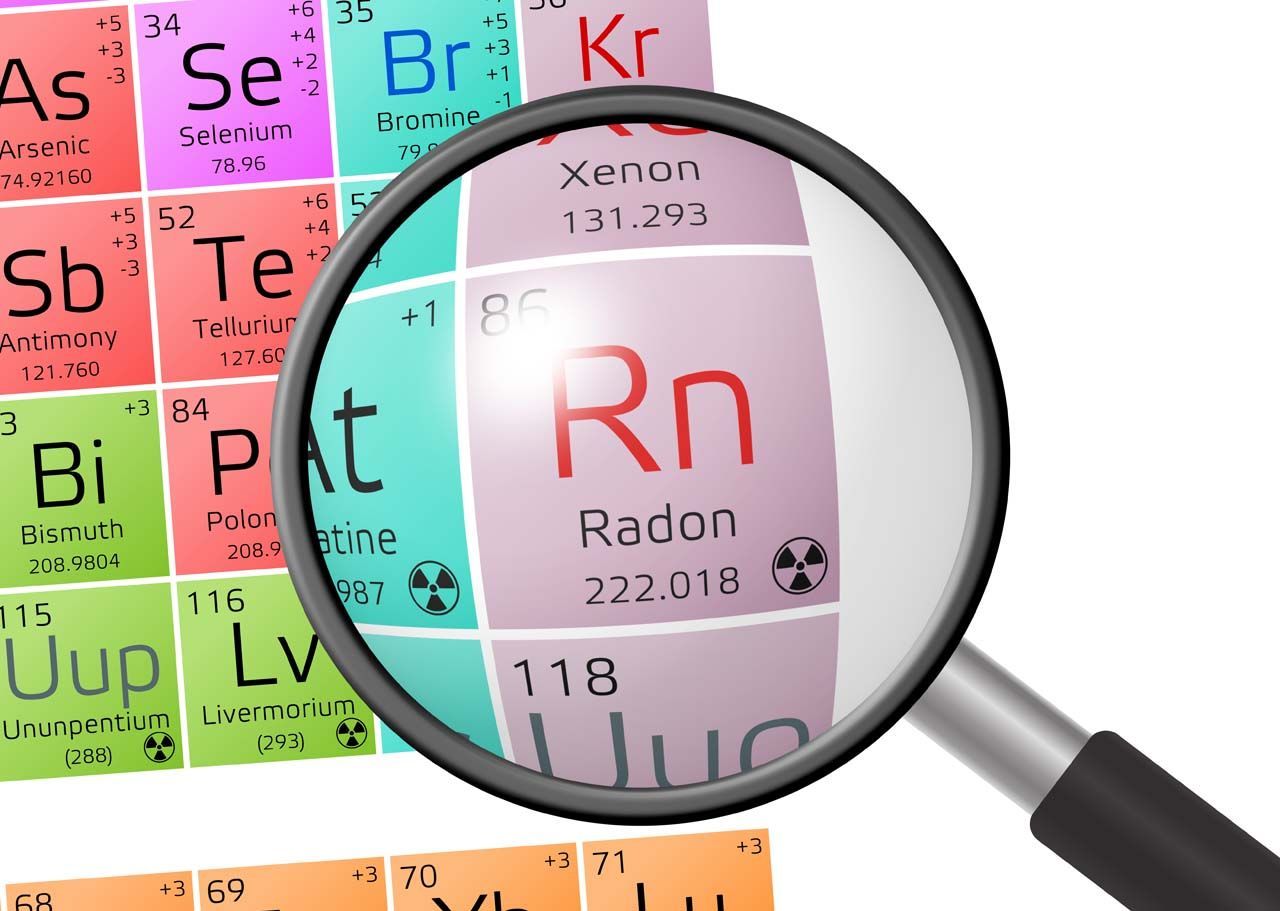 Magnifying glass highlighting radon on a colorful periodic table