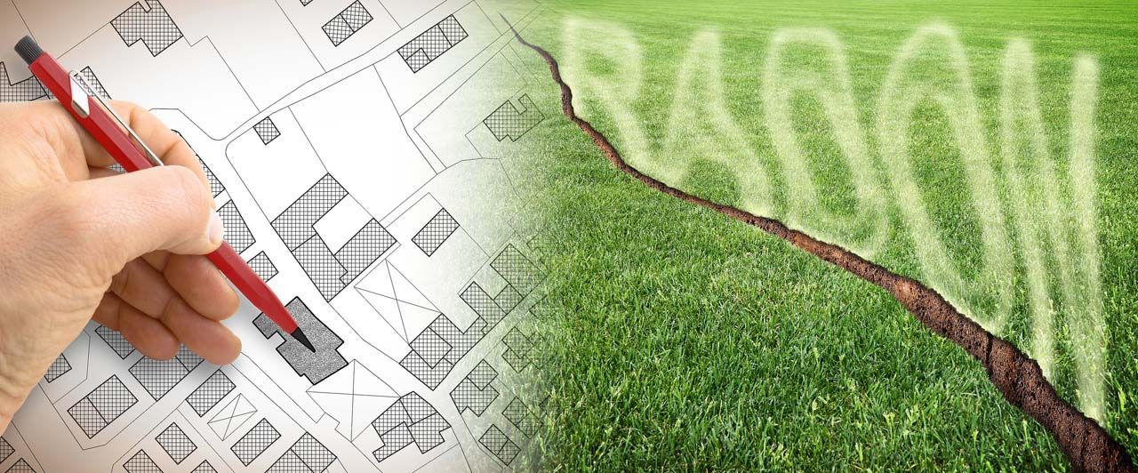 Hand drawing a house plan beside a green field with a graph line, suggesting eco-friendly building design