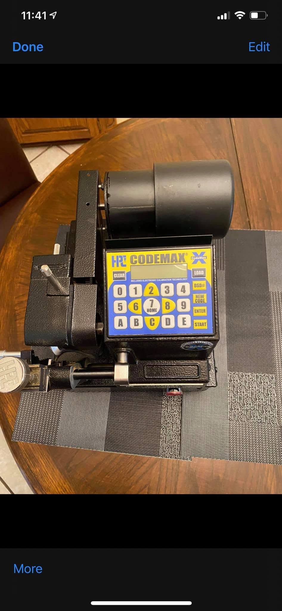 Yellow keypad device mounted on a black bracket on a patterned carpet