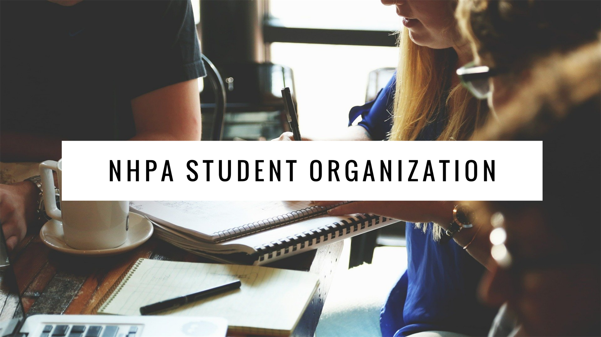 NHPA Student Organization banner over a meeting table with people in the background