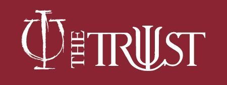The Trust logo in white on a maroon background, featuring a stylized psi symbol.