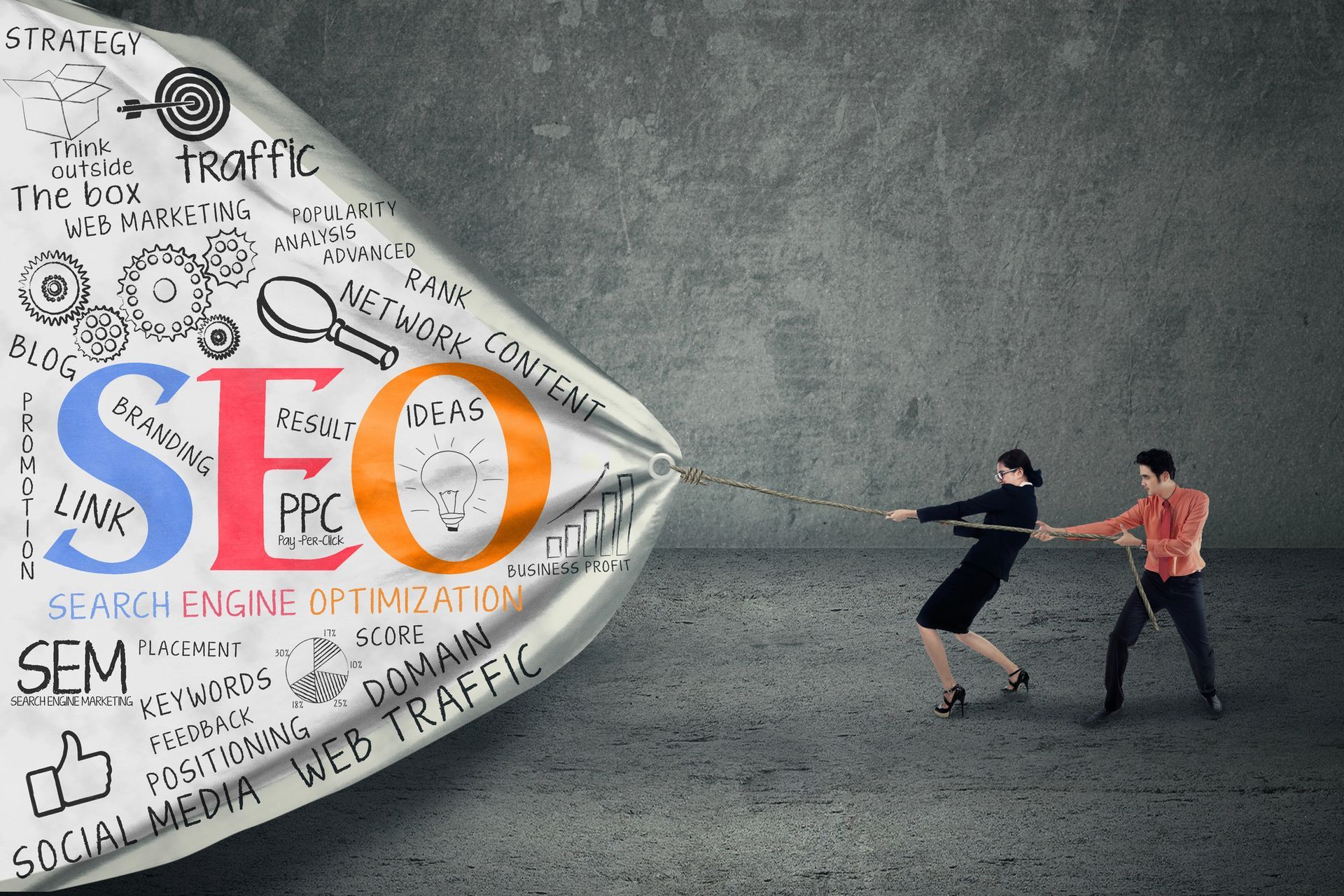 A man and a woman are pulling a banner with the word seo on it