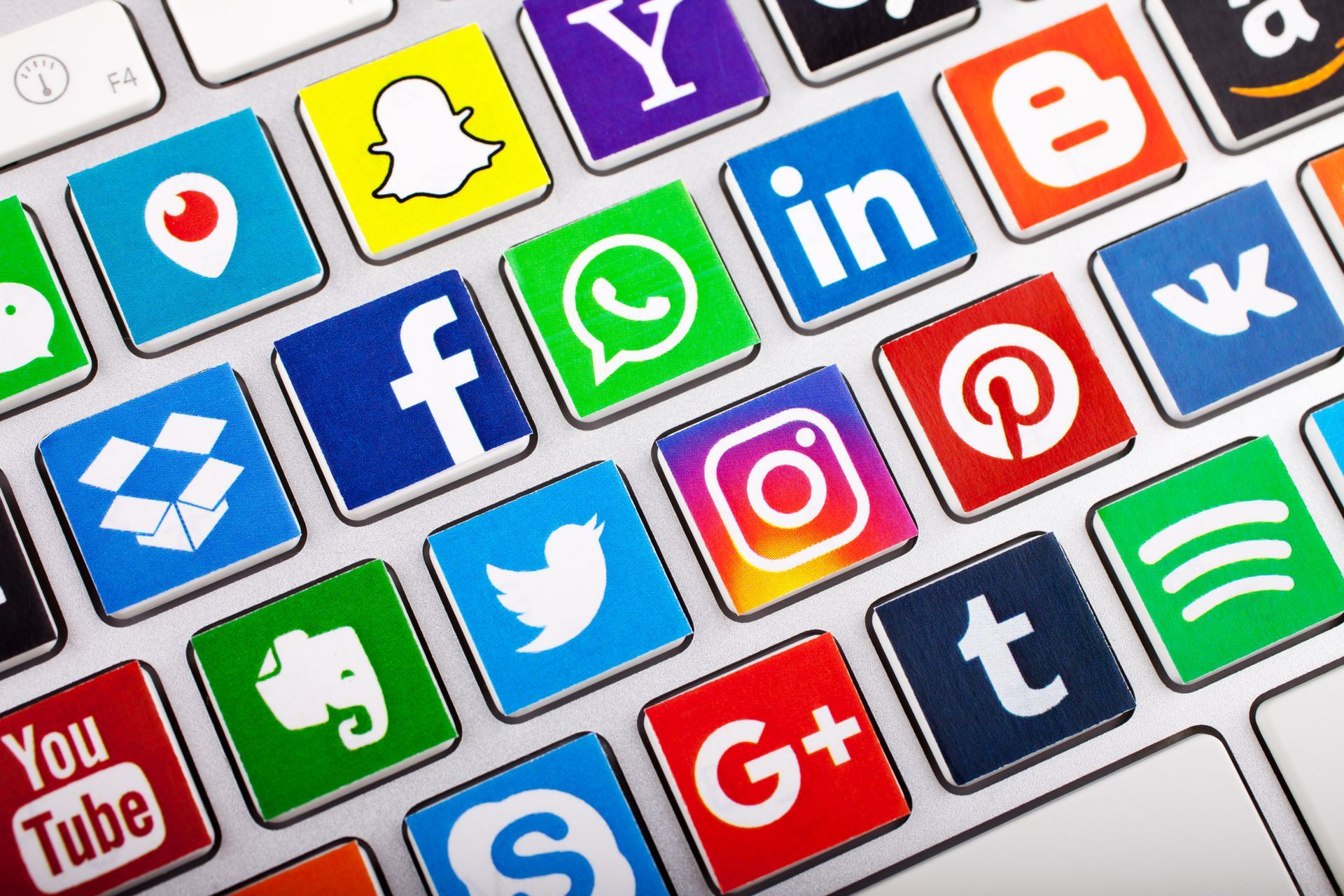 A keyboard with a bunch of social media icons on it