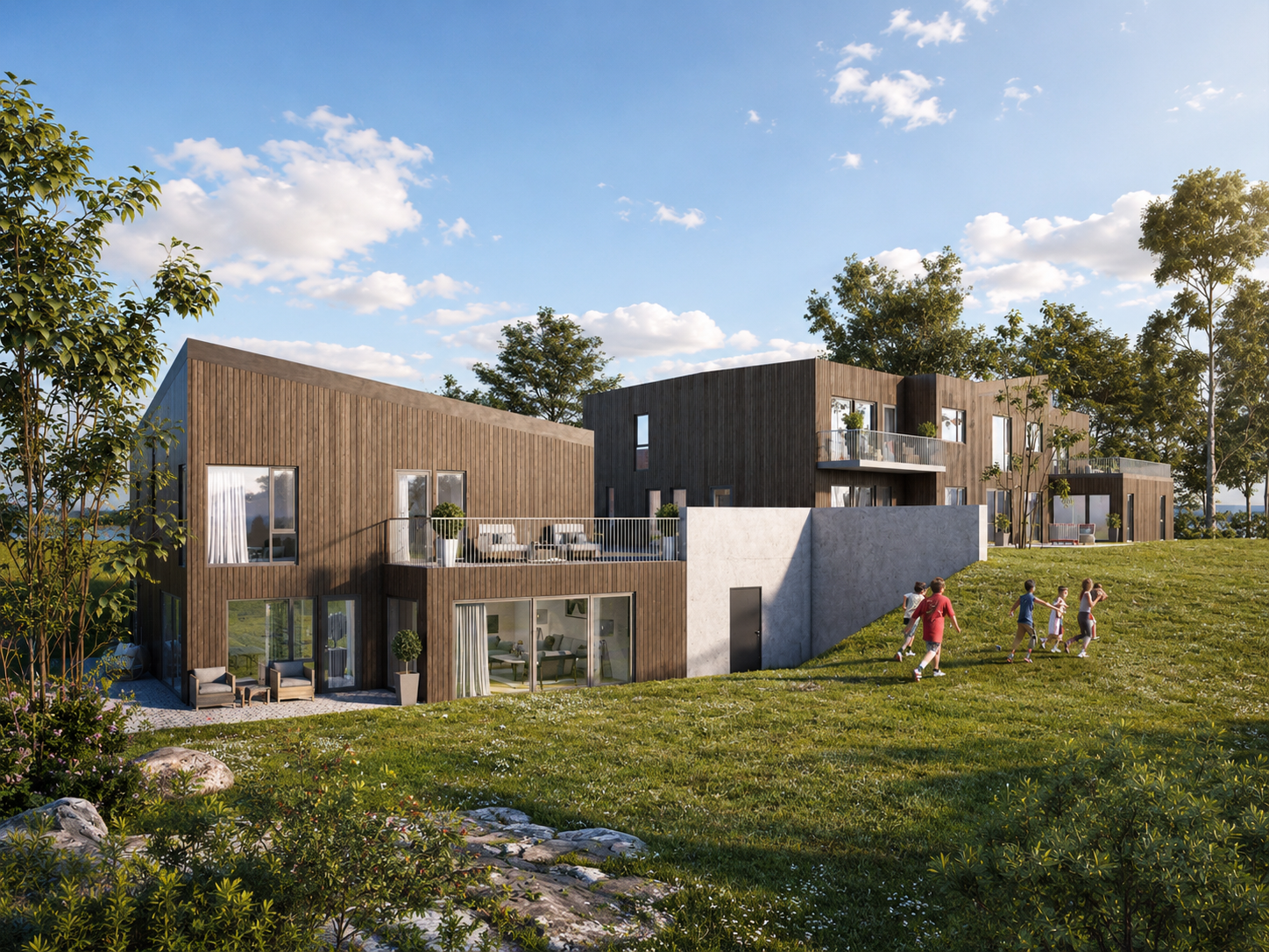Moderne trekledde leilighetsbygg i en gresskledd åsside med folk som går ute under en blå himmel.