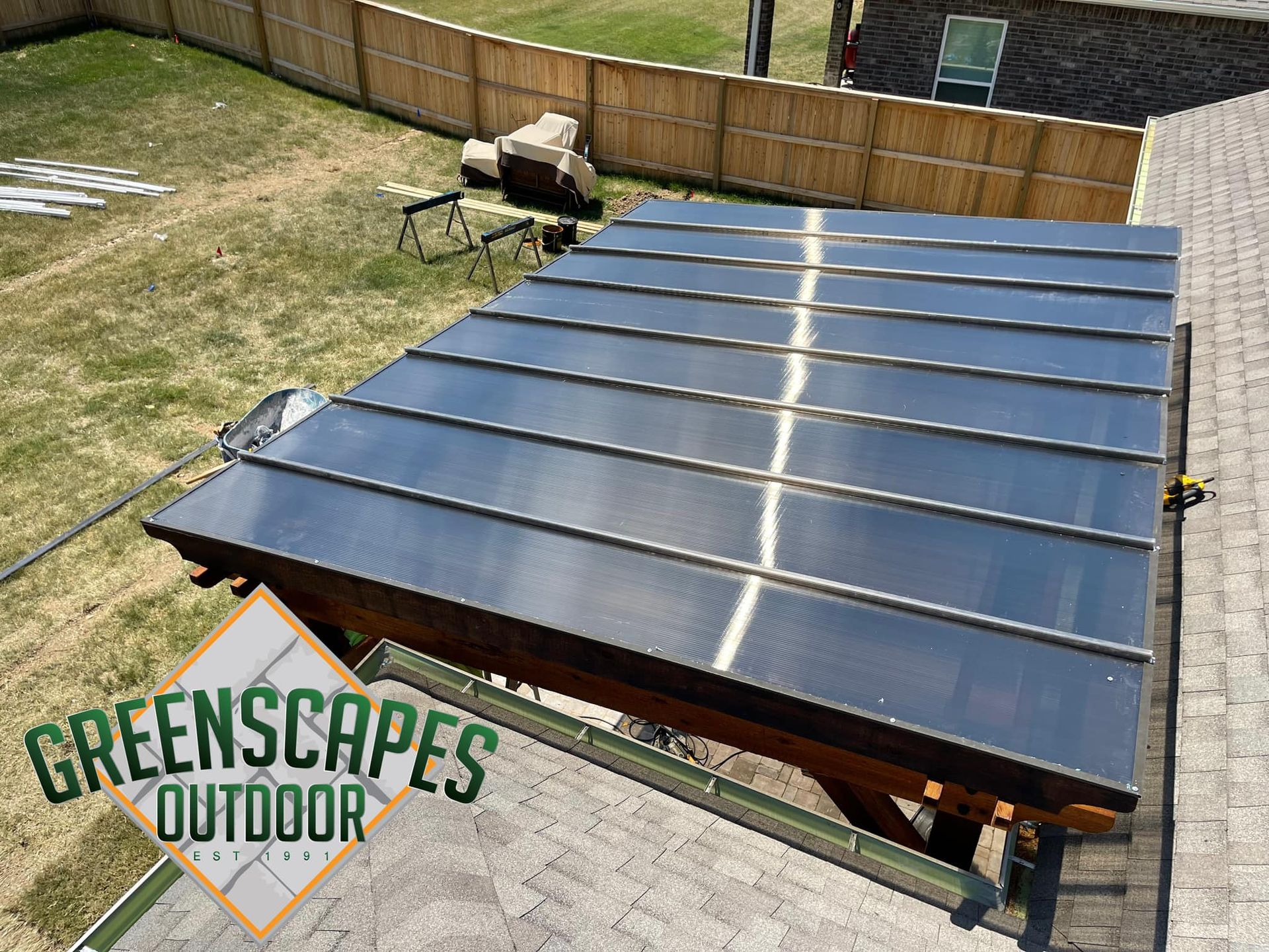 A roof with a greenscapes outdoor logo on it