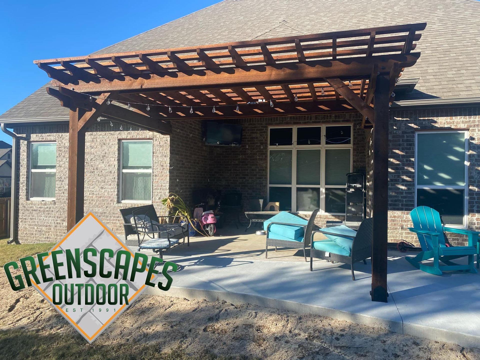 A house with a pergola and chairs in front of it