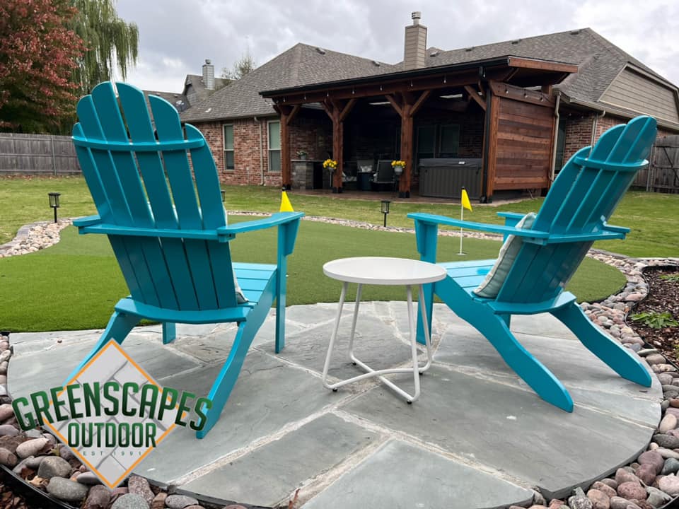 Backyard design with teal chairs