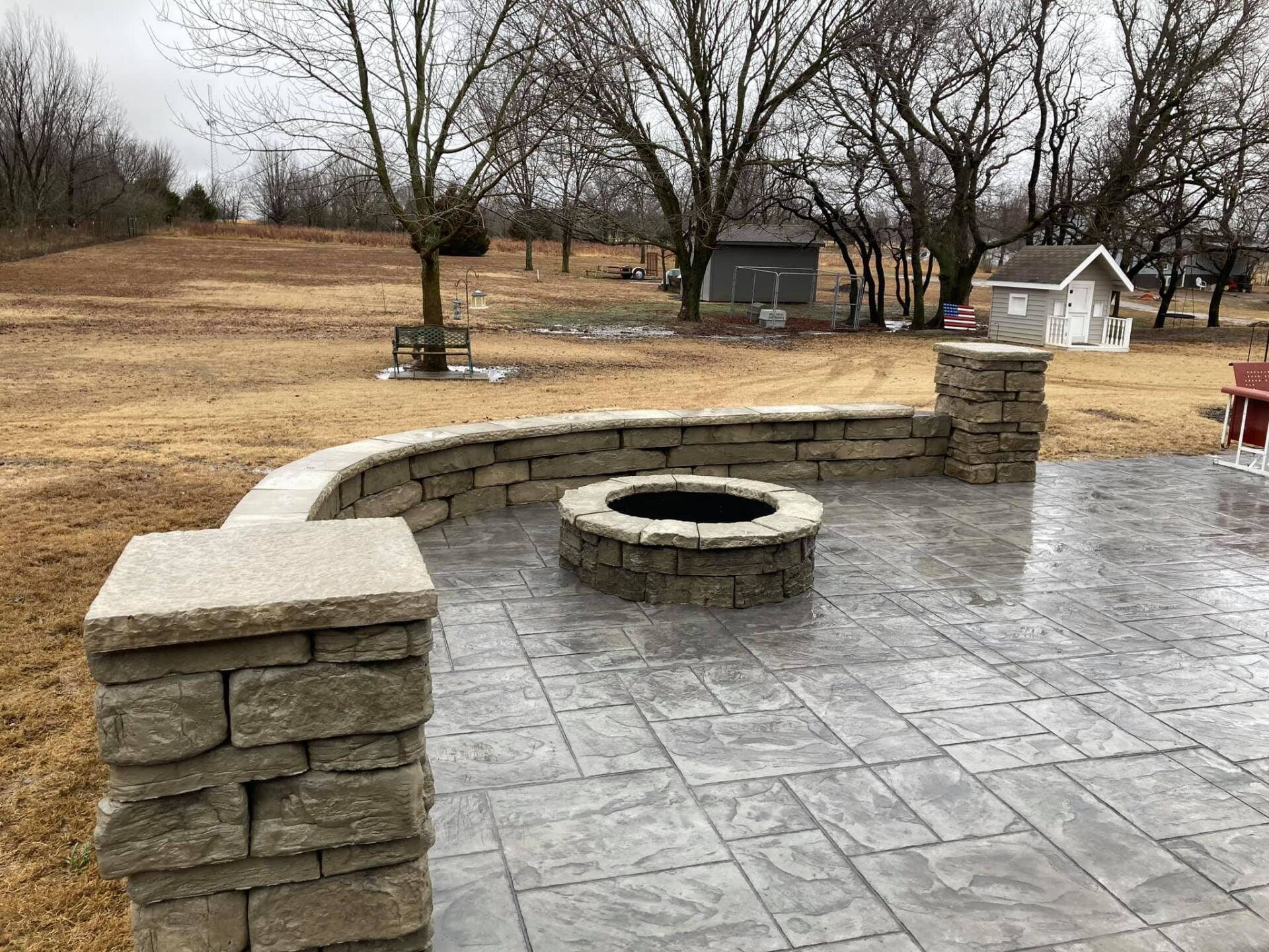 There is a fire pit in the middle of the patio.