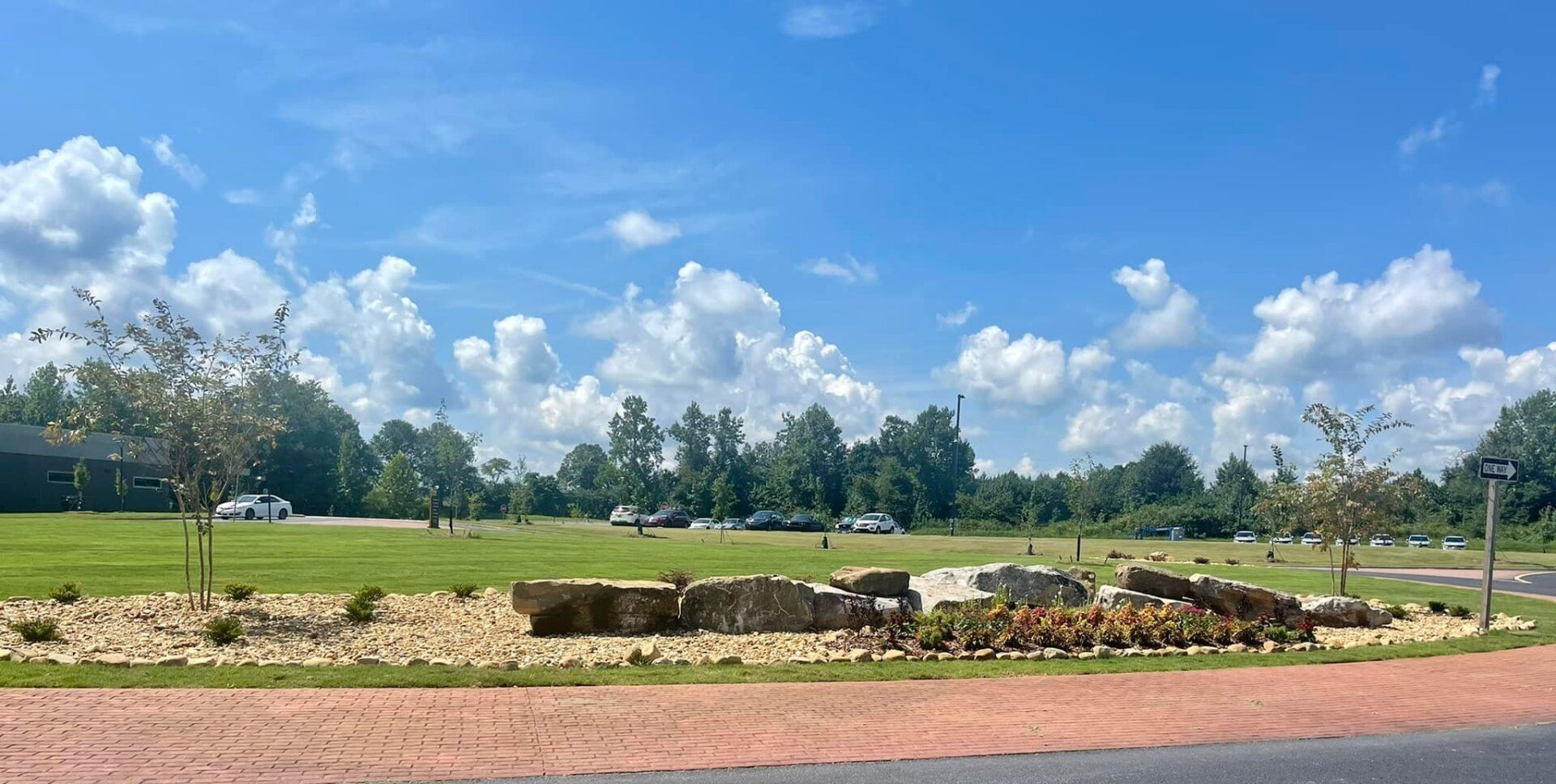 A large grassy field with trees.