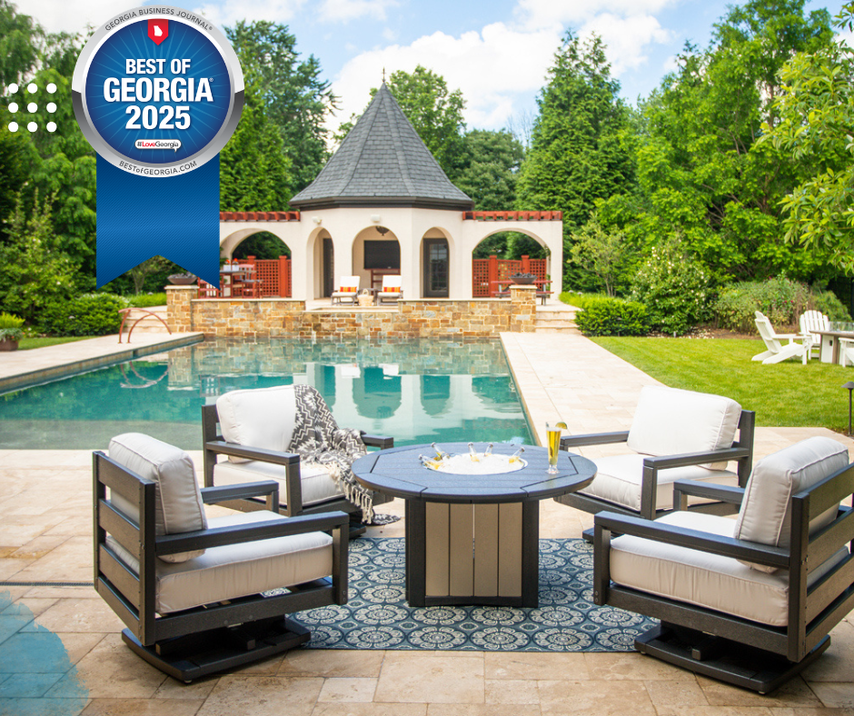 Luxury poolside patio with lounge chairs, fire table, and a stone pavilion beside a turquoise pool