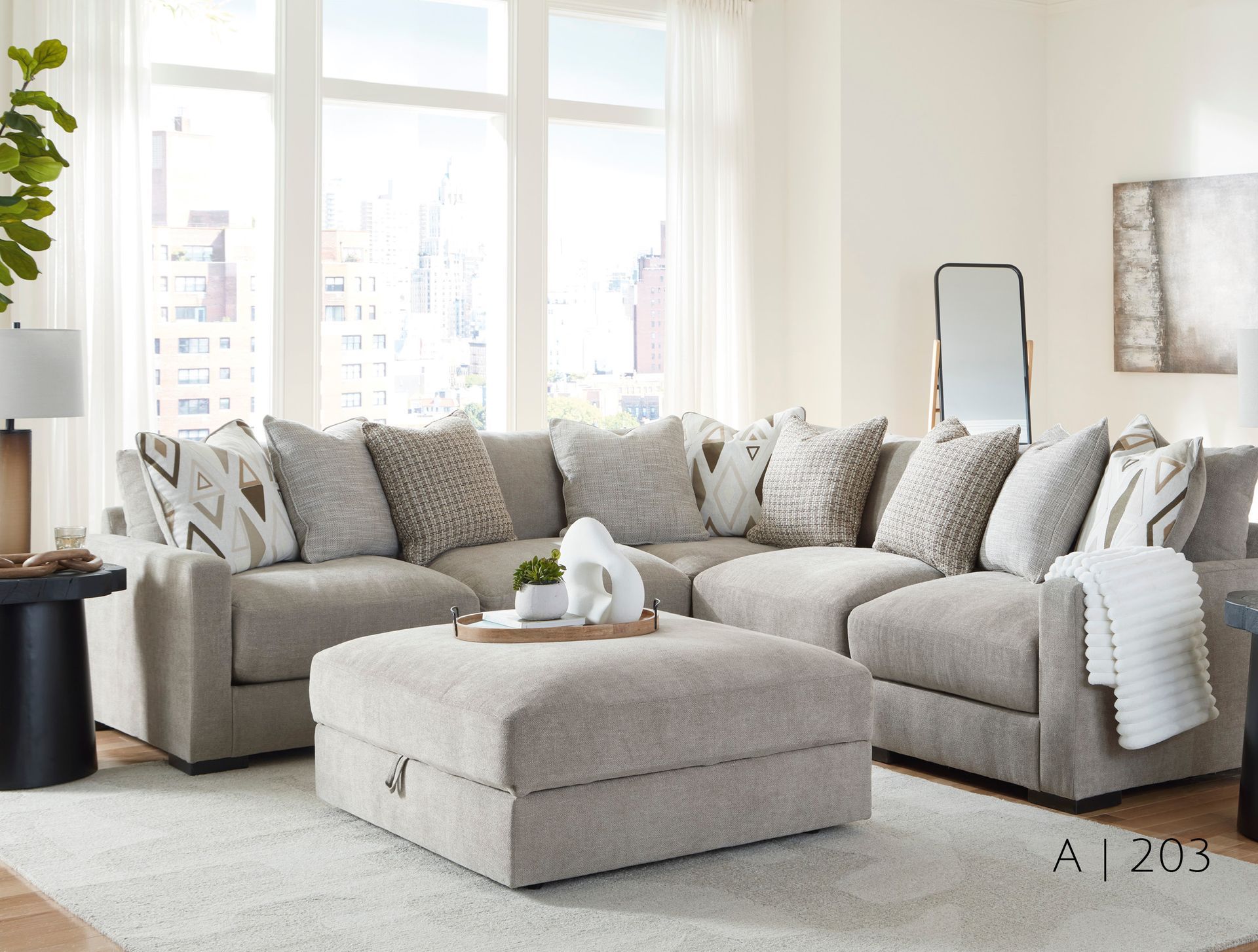 Sectional sofa with ottoman in neutral colors, pillows
