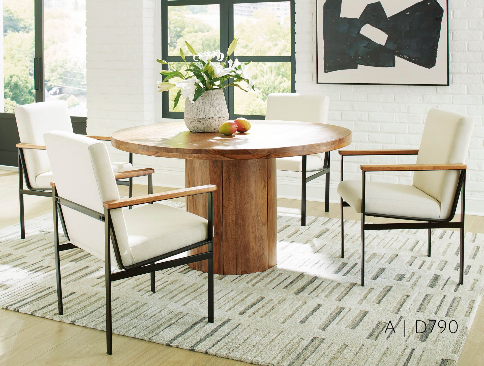 Dining room with wooden table, four chairs with white cushions, and a rug.