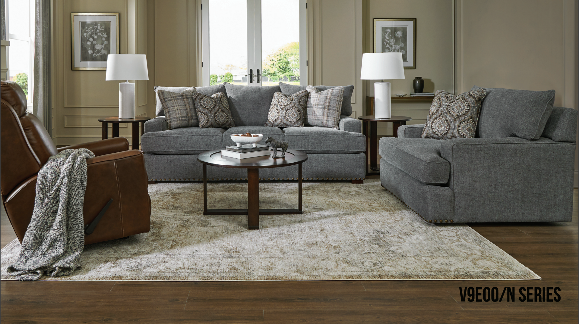 Living room furniture set: gray sofa, loveseat, brown recliner, rug, coffee table, lamps.