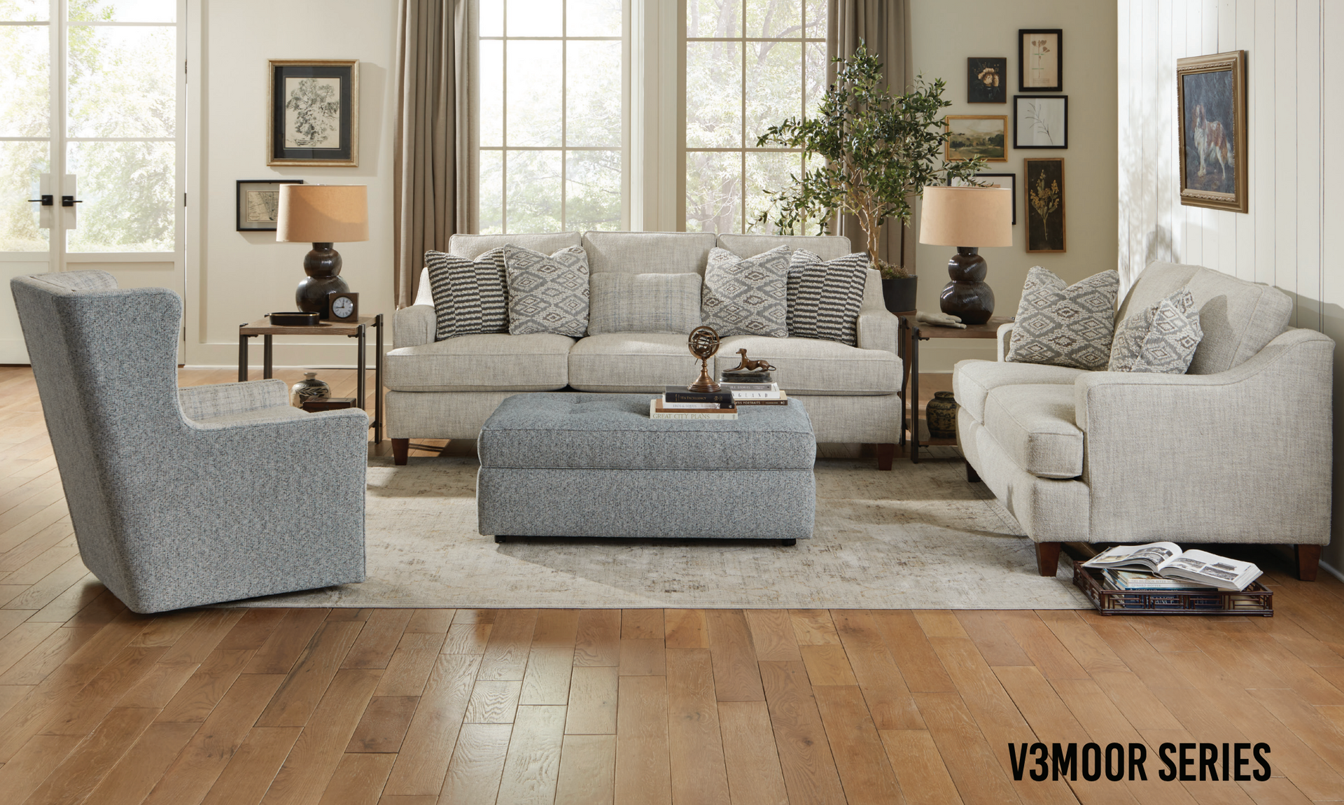 Living room furniture set with a sofa, chair, ottoman, and decor on a light wood floor.