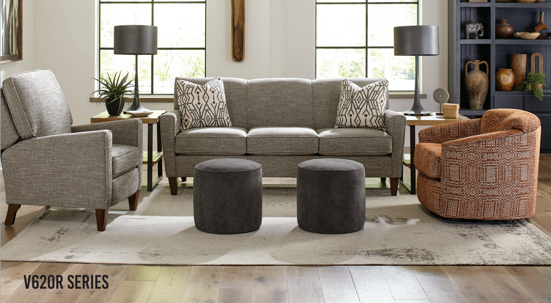 Living room furniture set with sofa, armchairs, ottomans, rug, and lamps