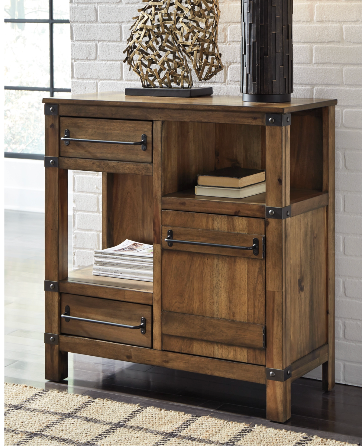 Wooden cabinet with two drawers and an open shelf, on a rug in front of a white brick wall.