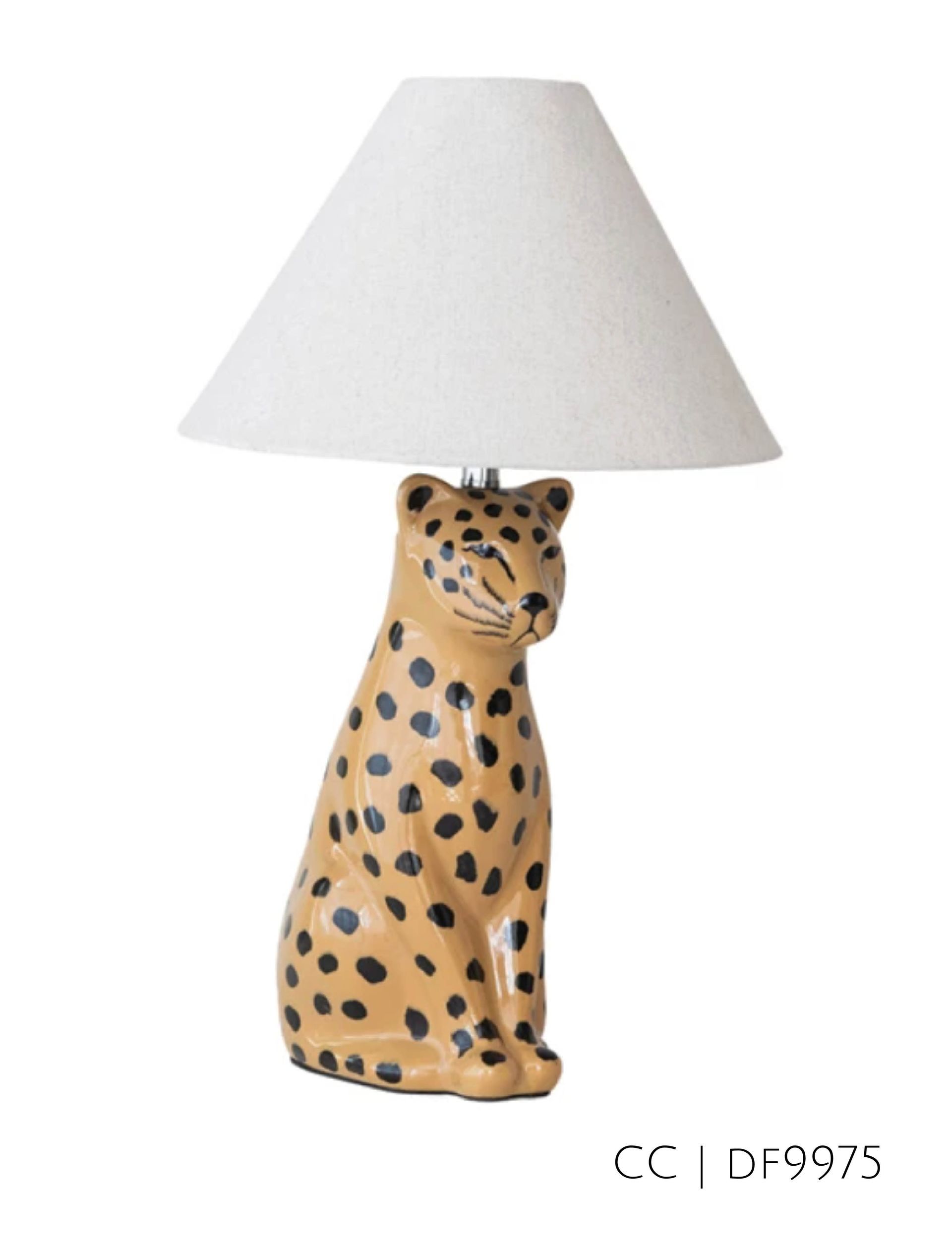 Tan leopard-shaped lamp with black spots and white lampshade.