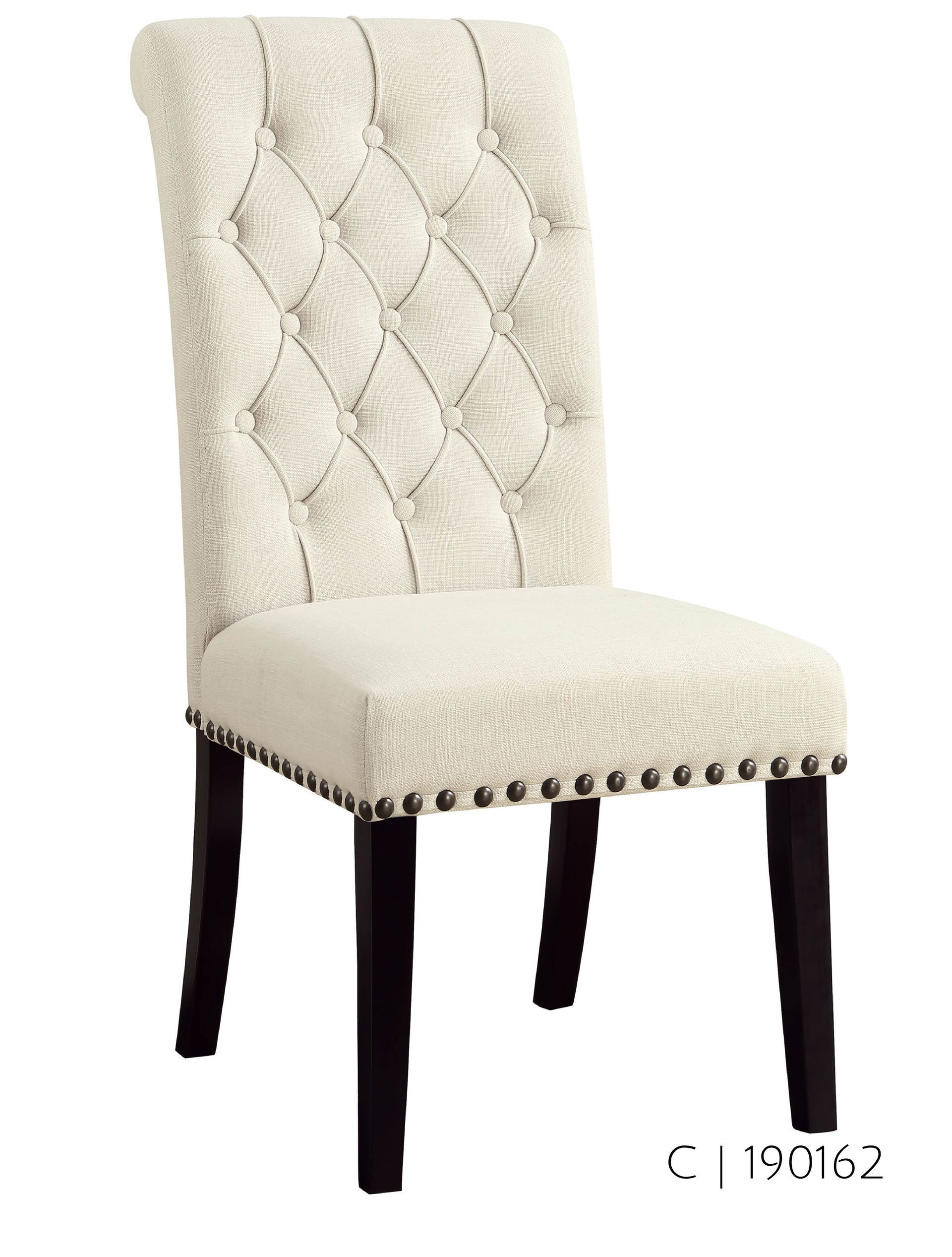 Cream-colored upholstered dining chair with button tufting on the back, dark legs, and nailhead trim.