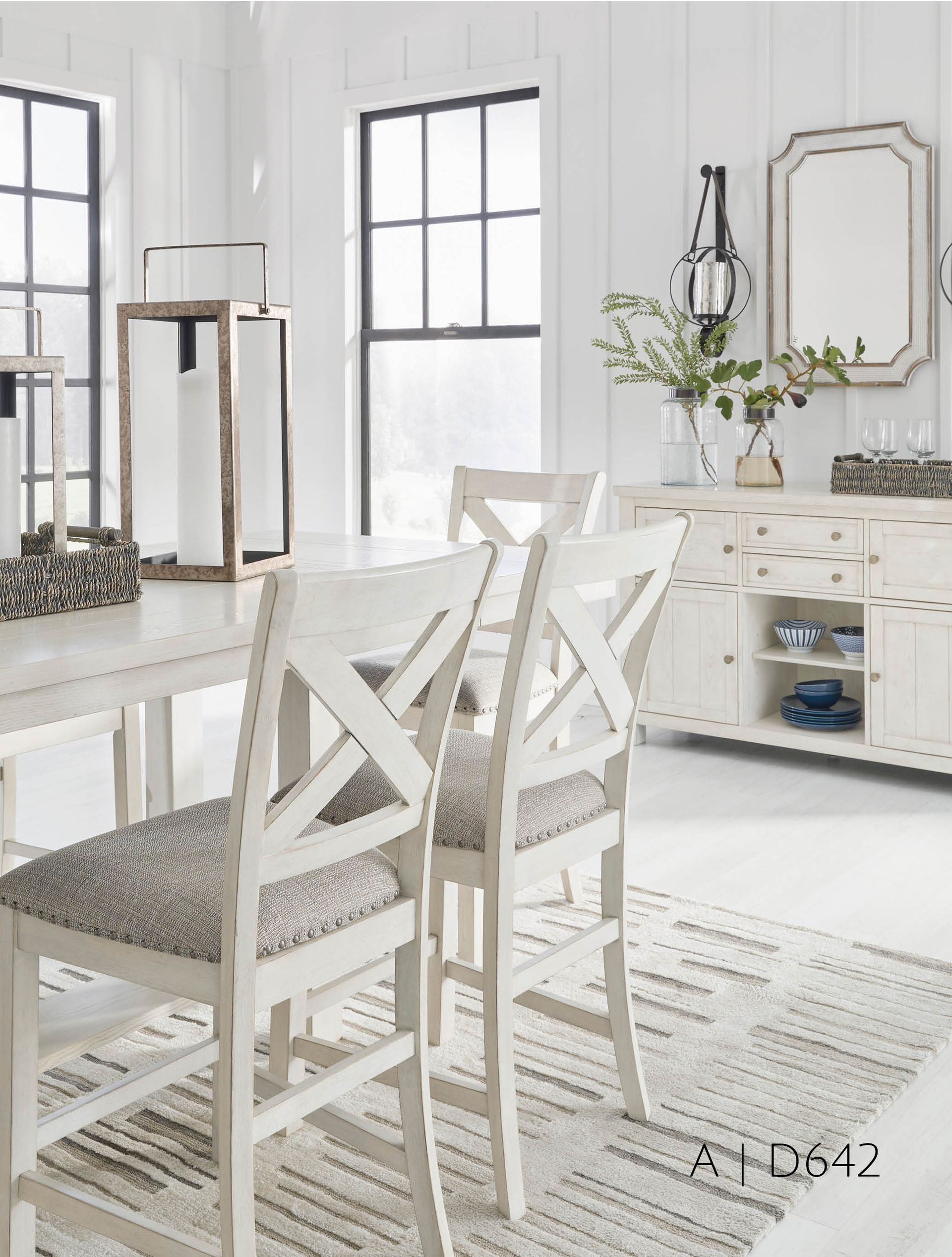 Dining room with white furniture, chairs, and window, and a gray rug.