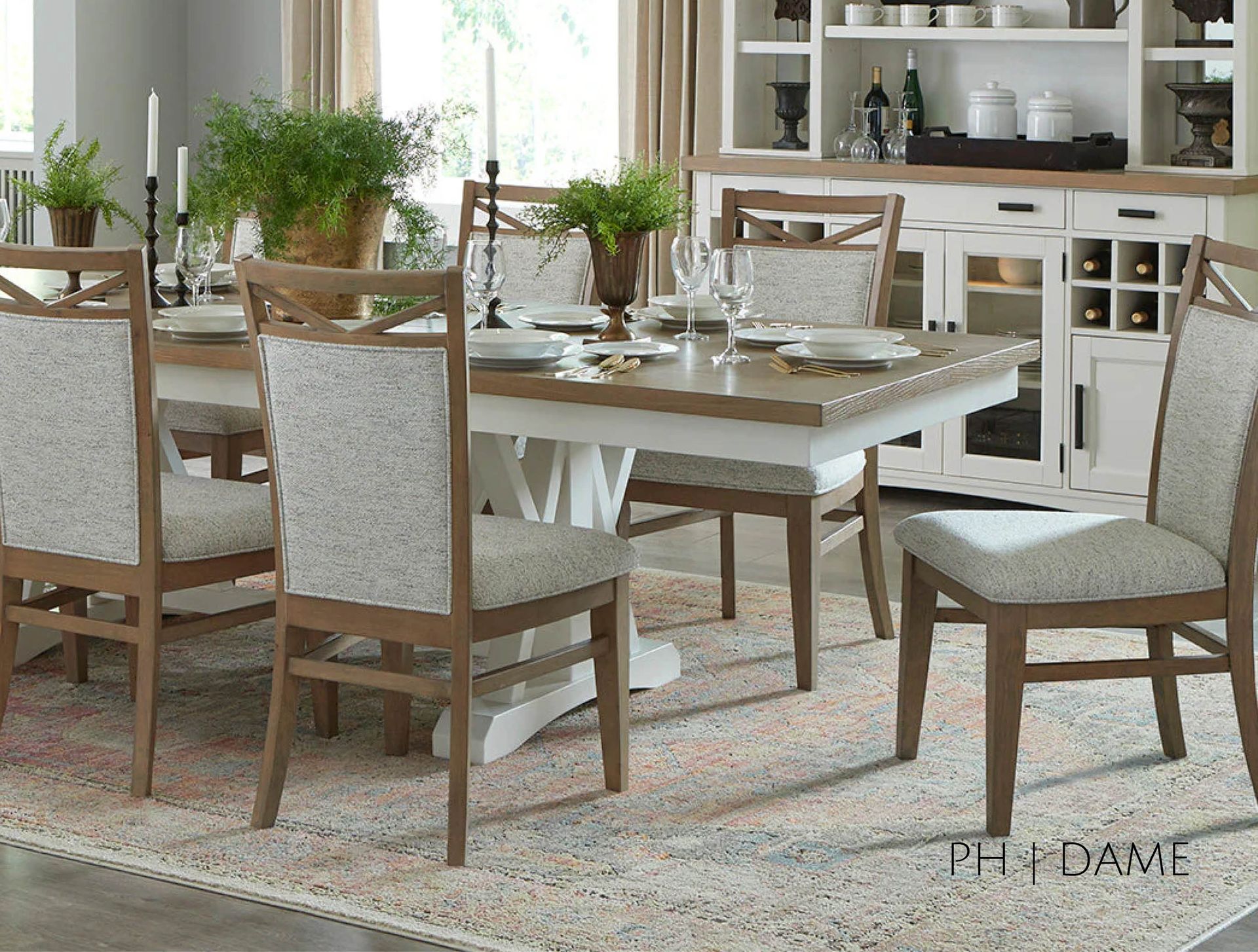 Dining room set: table with chairs, buffet, and rug. Light wood and white accents with neutral patterned fabric on chairs.