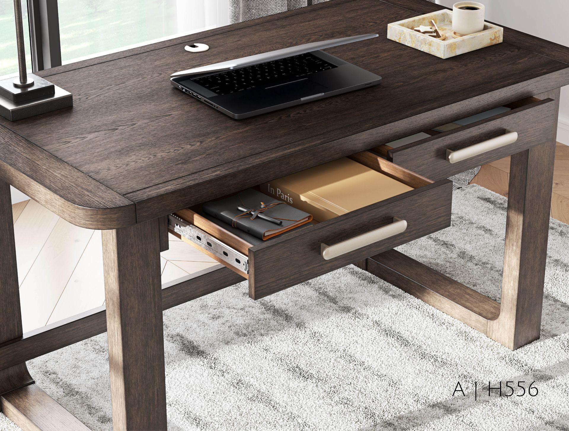 Dark wooden desk with an open drawer containing office supplies and a laptop on top.
