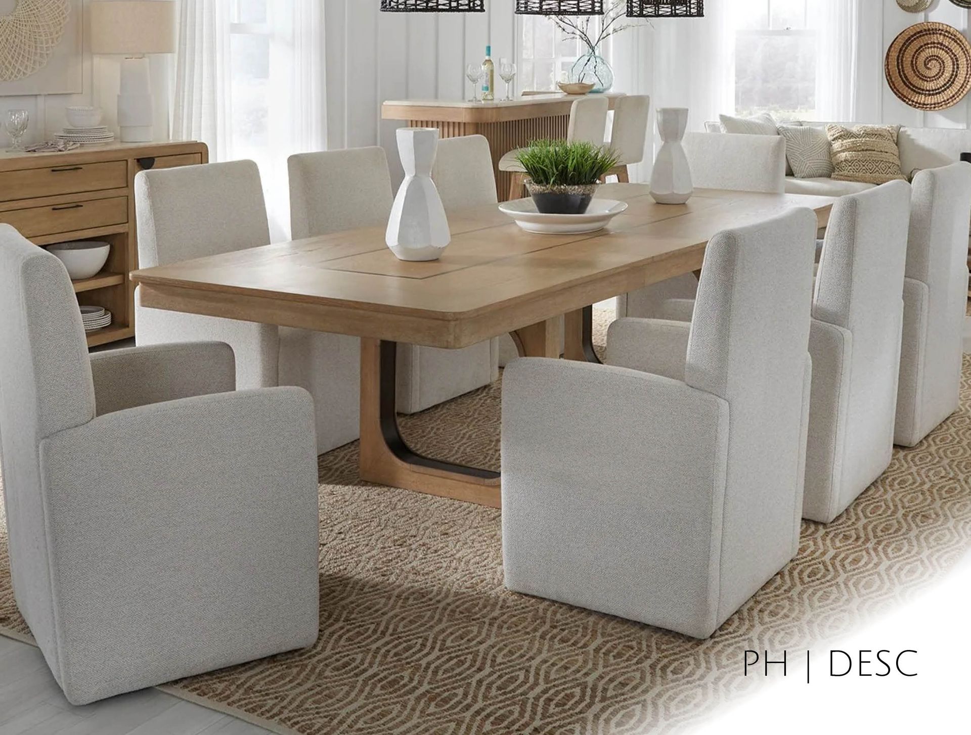 Dining room with light wood table, eight white chairs, neutral rug, and buffet.