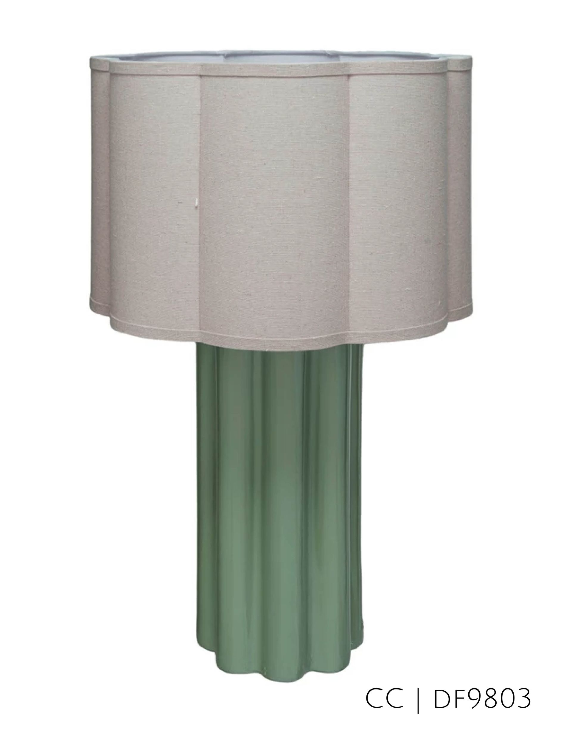 Green fluted lamp with a beige scalloped lampshade.