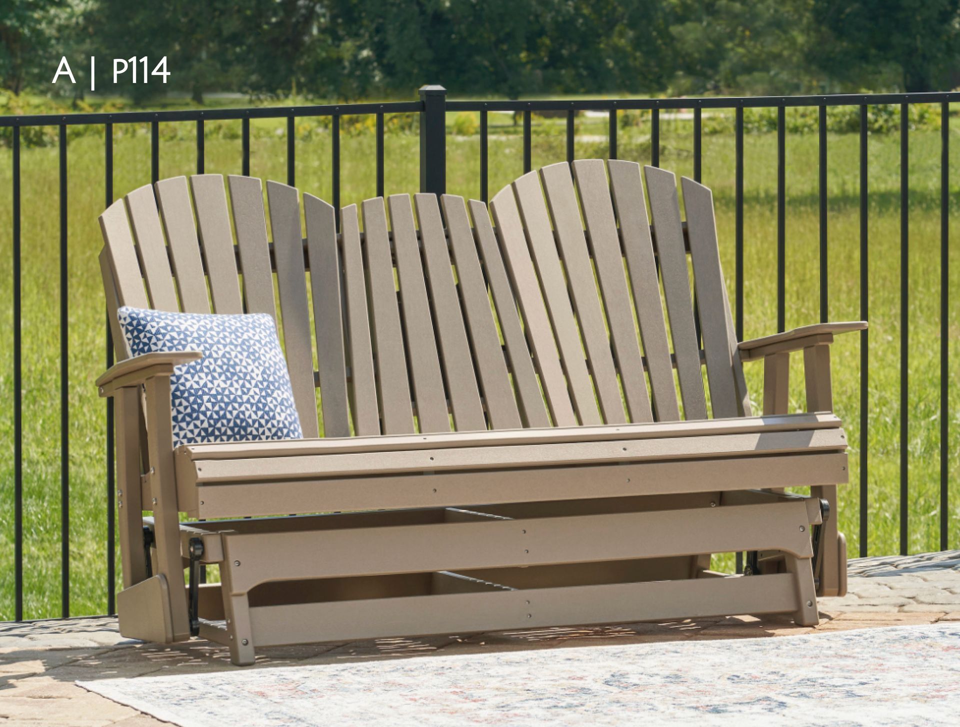 Tan outdoor glider bench with a blue and white patterned pillow.