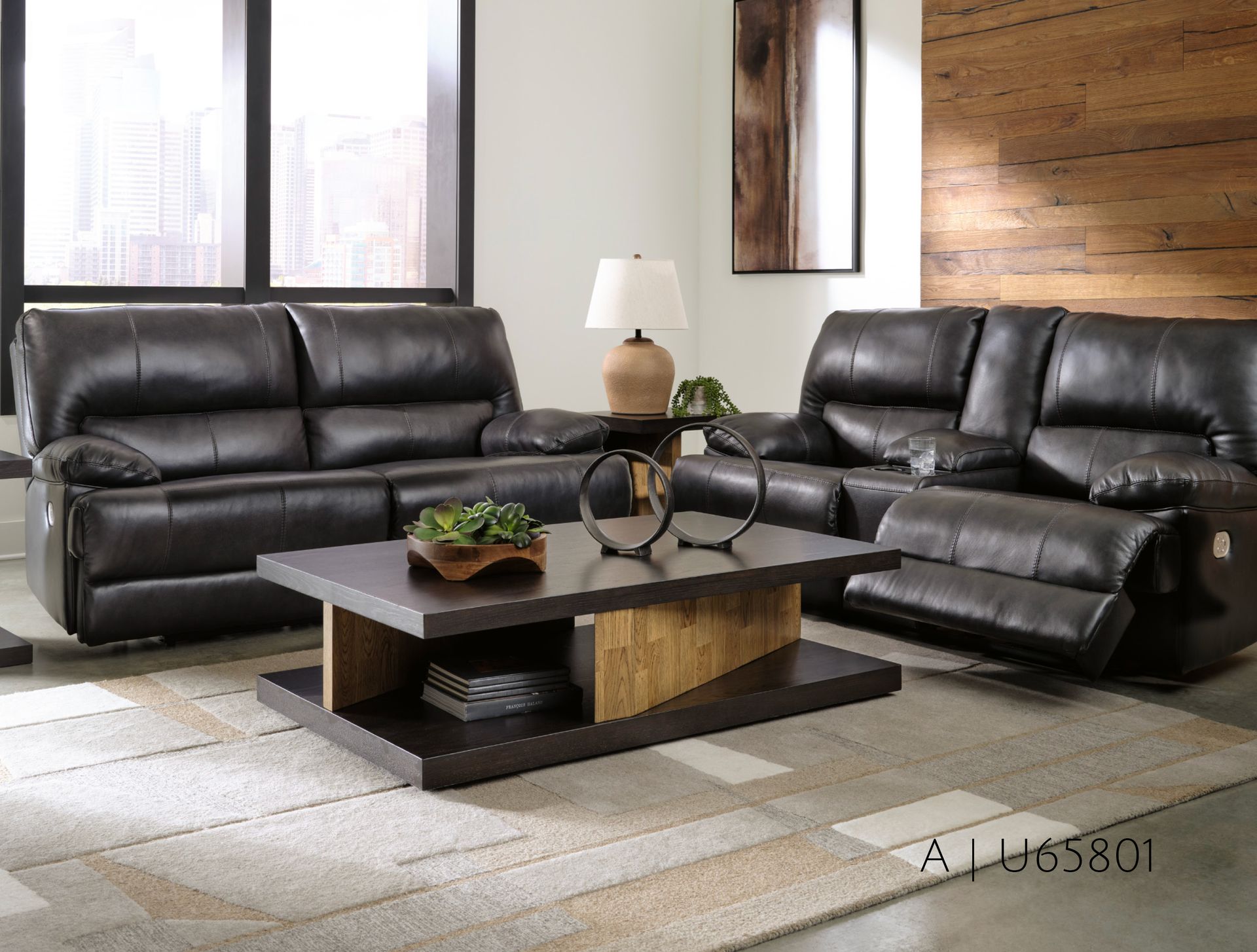 Living room with dark brown leather sofa set, wooden coffee table, and lamp.