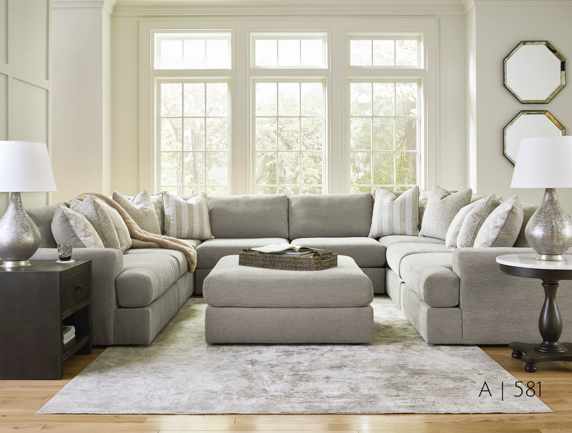 gray sectional sofa, ottoman, lamps, rug,