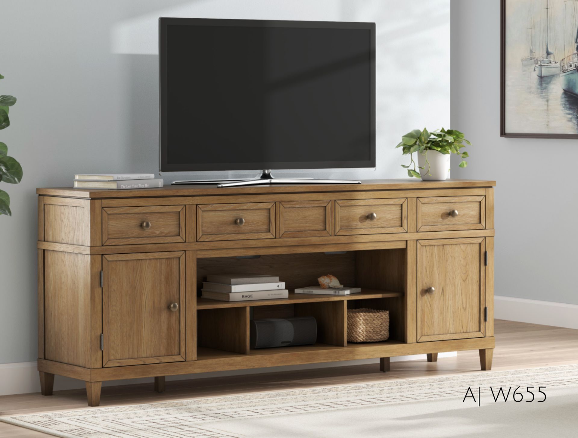 Wooden TV console with TV on top, drawers, and cabinet doors.